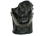 sculpture of a man ' s head with a black background