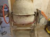 a cement mixer sitting in the corner of a room