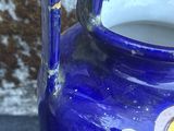 a blue vase with a dragon on it sitting on a table