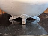 a large white bowl sitting on top of a black table