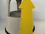 a yellow arrow that is on top of a white table