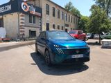 a blue car that is parked in front of a building