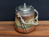 a glass jar with a lid on a wooden table