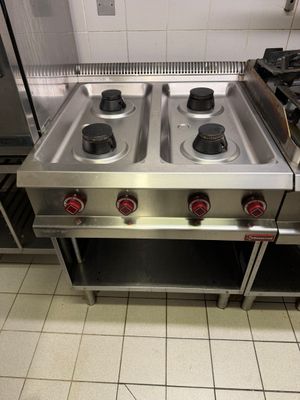 three burners on the stove in the kitchen