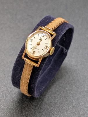 une image représentant une montre-bracelet avec un bracelet bleu et un cadran doré