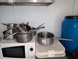 des casseroles et des poêles posées sur une cuisinière dans une cuisine