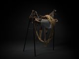 a black and white photo of a horse ' s saddle on a black background