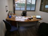 a desk with a laptop and a laptop computer on it