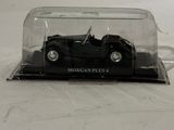 a black model of a car in a glass case