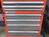 a close up of a red tool cabinet in a garage