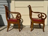 two chairs sitting next to each other on the sidewalk