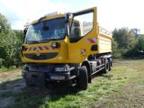 a yellow truck that is parked in the grass