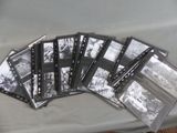 a lot of old black and white photos on a table