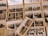 a lot of old black and white photos on a table