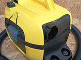 a yellow and black blow dryer sitting on the floor