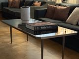 a living room with a couch, coffee table, and lamp