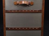 an old suitcase with three drawers on top of it