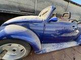 a blue vw buggy parked on the side of the road