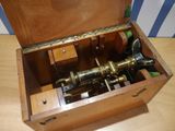 a wooden box with a musical instrument inside of it