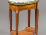 a small wooden table with a marble top and a shelf