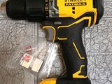 a close up of a cordless drill on a tiled floor