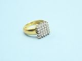 a close up of a gold and diamond ring on a blue surface