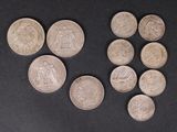 six different types of coins are arranged on a black surface