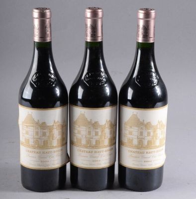 three bottles of wine sitting on top of a table next to each other