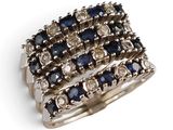 a close up of a ring with blue and white stones on it