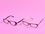 une paire de lunettes sur fond rose