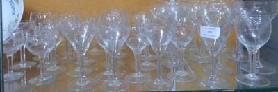 many empty wine glasses on a shelf in a store