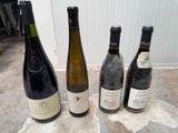 several bottles of wine are lined up on a table