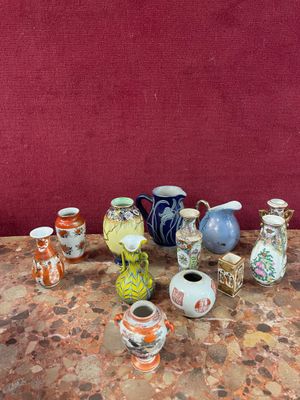 many different vases sitting on a table with a red wall in the background