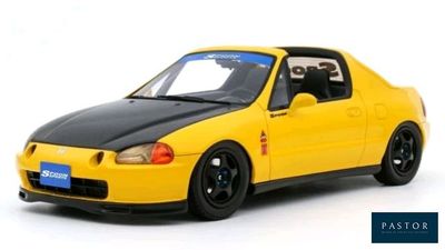 the yellow car is parked on a white surface with a white background