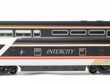 three model trains sitting side by side on a white surface