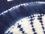 a close up of a tie dye shirt with a tag on it