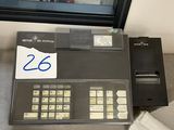 a cash register sitting on a counter in front of a window