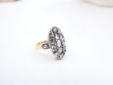 a close up of a diamond ring on a white surface