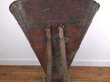 a large metal object on a wooden floor in a room