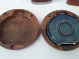 three wooden plates and a bowl on a table