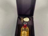 an image of a bottle of perfume in a box on a table