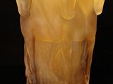 a close up of a glass vase on a black surface
