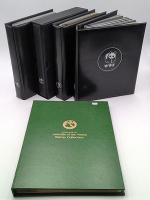 three black and green books sitting next to each other on a table