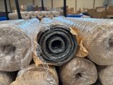 a pile of rolls of plastic wrapped up in a warehouse