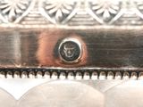a close up of a silver plate with a clock on it