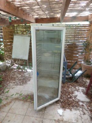 une photo d'un réfrigérateur qui se trouve dehors, dans le jardin