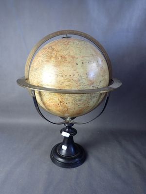 an old model of a terrestrial globe on a metal stand