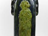 a blue vase with a green design on it