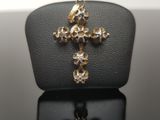 a gold cross on a black surface with a white background
