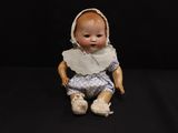 a small doll that is sitting on a black surface